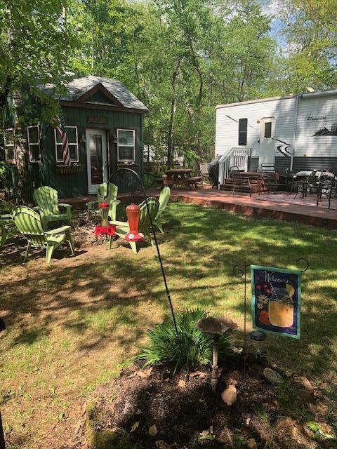 view of grassy yard featuring a deck