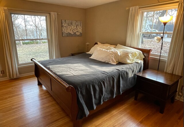 3918 Willmatt Hl, Minnetonka, MN 55305 - bedroom featuring light wood finished floors, multiple windows, and baseboards