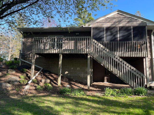 3918 Willmatt Hl, Minnetonka, MN 55305 - back of property featuring a sunroom, a wooden deck, and stairs