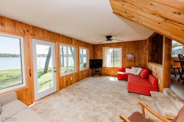 20850 Leona Beach Rd, Erie Twp, MN 56578 - carpeted living room with wood walls, a water view, and ceiling fan