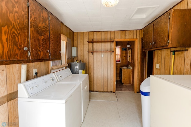 20850 Leona Beach Rd, Erie Twp, MN 56578 - clothes washing area with washer and dryer, electric water heater, cabinet space, and wood walls