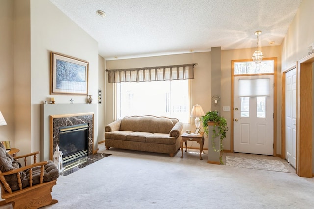 carpeted living room featuring plenty of natural light, a textured ceiling, and a premium fireplace