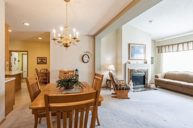 carpeted dining room with a high end fireplace, a textured ceiling, a chandelier, recessed lighting, and lofted ceiling