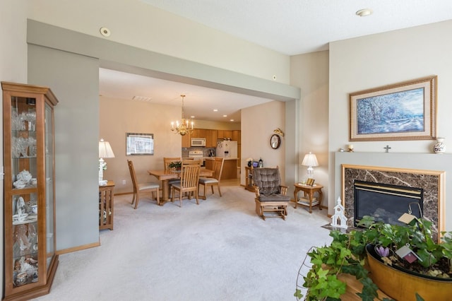 living area featuring light colored carpet, a chandelier, a high end fireplace, baseboards, and recessed lighting