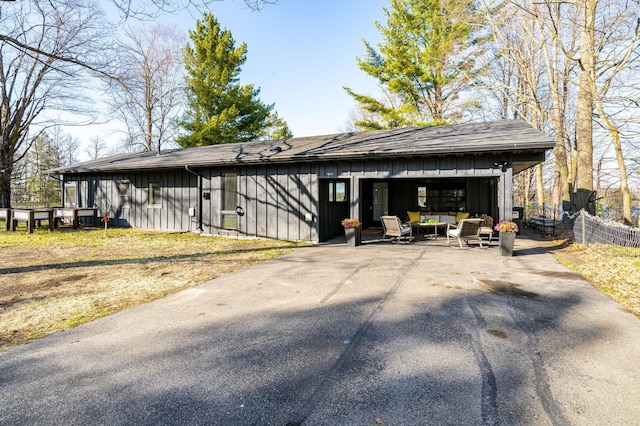 20380 Crystal Springs Loop, Harris Twp, MN 55744 - view of front of home with board and batten siding, roof with shingles, and asphalt driveway