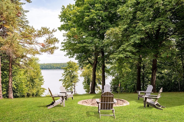 20380 Crystal Springs Loop, Harris Twp, MN 55744 - view of green lawn with an outdoor fire pit and a water view