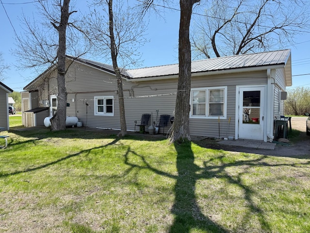 27096 Little Floyd Lake Rd # 10, Detroit Lakes, MN 56501 - rear view of property with a lawn, metal roof, a storage unit, and an outdoor structure