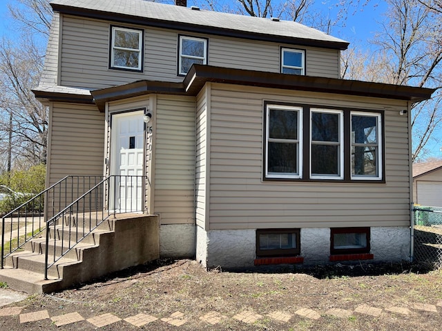 view of front of home with fence and a chimney