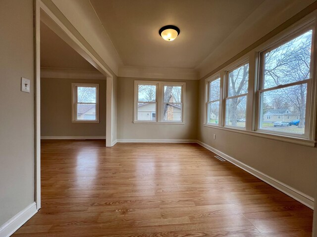 unfurnished room featuring wood finished floors and baseboards
