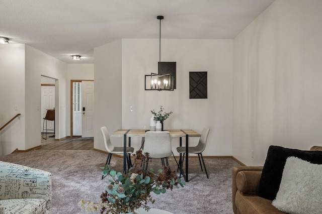 dining space with carpet flooring, a chandelier, and baseboards