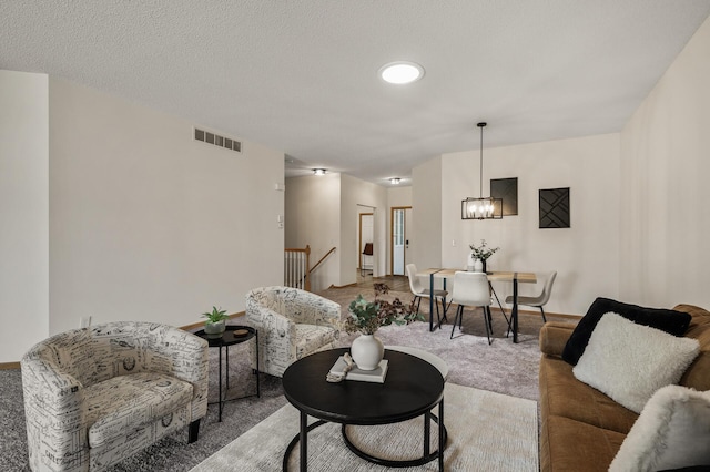 living room with carpet, a chandelier, and baseboards