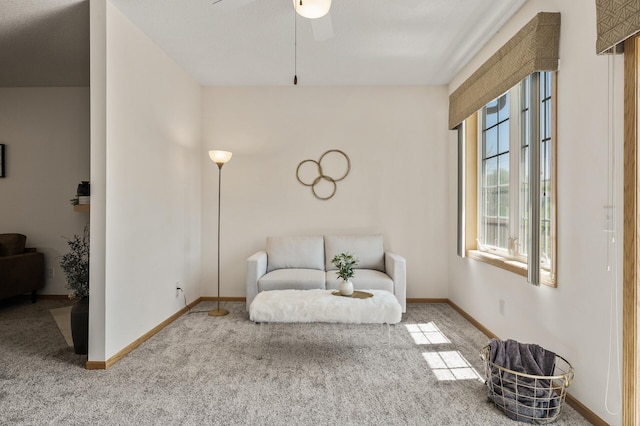 living area with plenty of natural light, carpet, ceiling fan, and baseboards