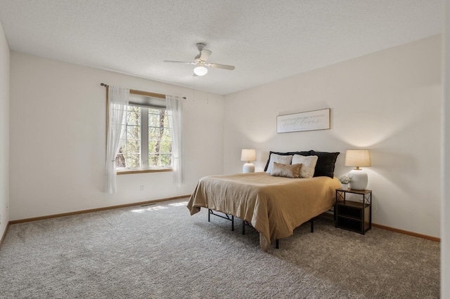 carpeted bedroom featuring baseboards, a textured ceiling, and a ceiling fan