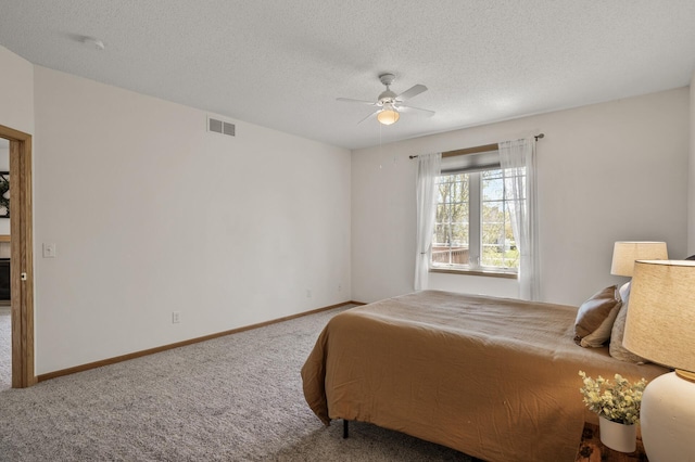 bedroom featuring carpet floors, a ceiling fan, baseboards, and a textured ceiling