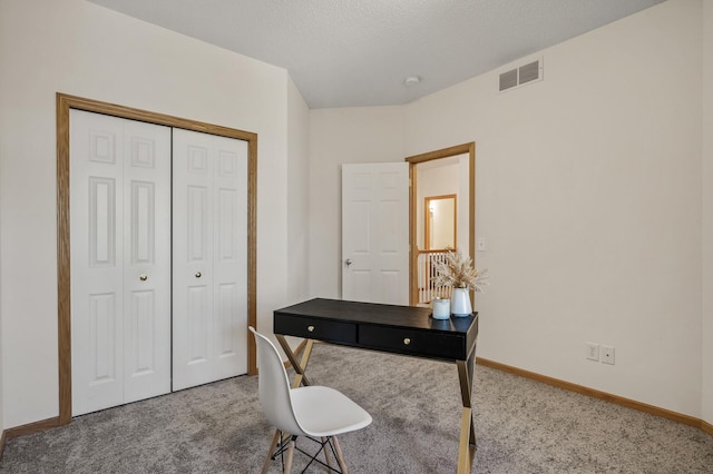 carpeted office space featuring baseboards