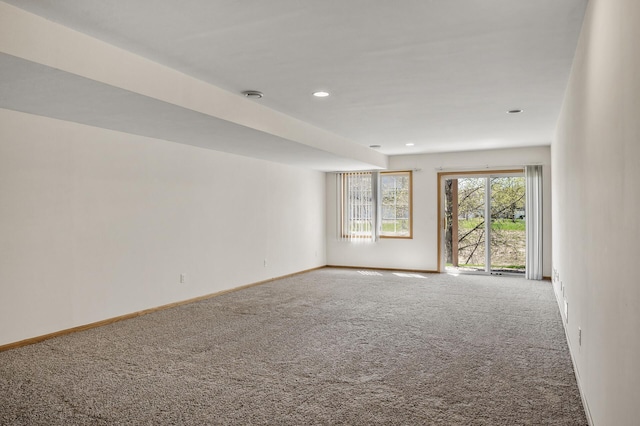carpeted empty room with baseboards and recessed lighting