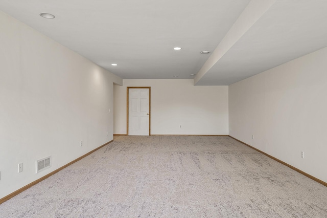 carpeted spare room featuring baseboards and recessed lighting