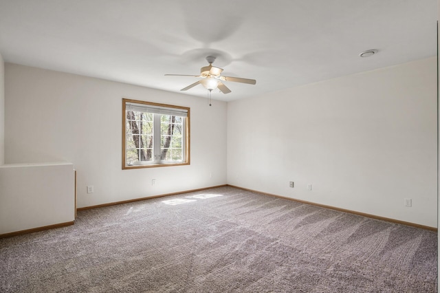 empty room with a ceiling fan, carpet flooring, and baseboards