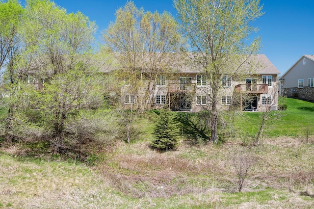 back of property featuring a deck and a yard