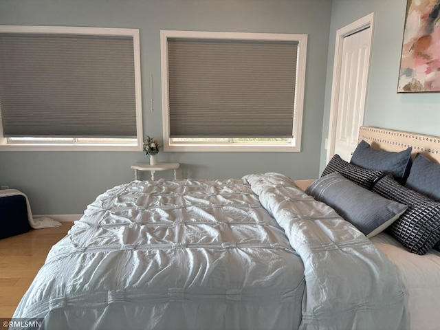 bedroom with wood finished floors and baseboards