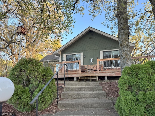 view of front of property with a wooden deck and stairs
