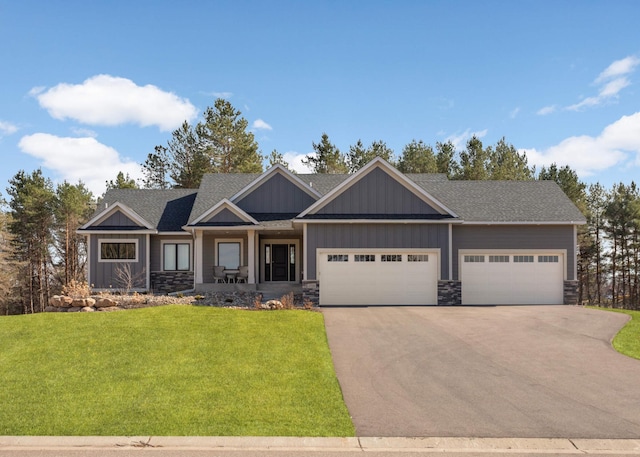15359 Quamba St NE, Ham Lake, MN 55304 - craftsman-style house with driveway, a front yard, a garage, board and batten siding, and stone siding