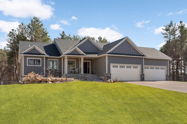 15359 Quamba St NE, Ham Lake, MN 55304 - craftsman-style house featuring board and batten siding, an attached garage, a front lawn, driveway, and covered porch