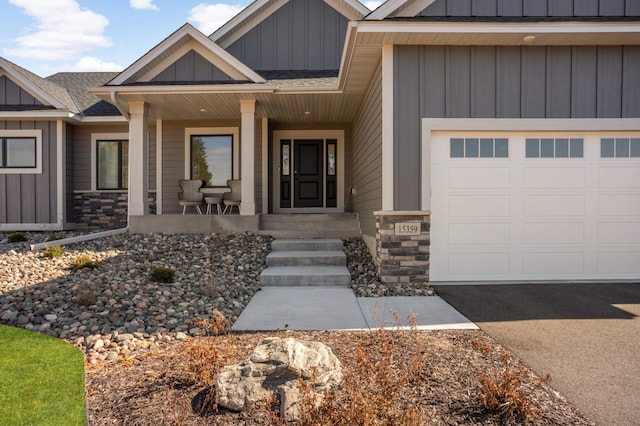 15359 Quamba St NE, Ham Lake, MN 55304 - property entrance with board and batten siding, a porch, stone siding, and a shingled roof