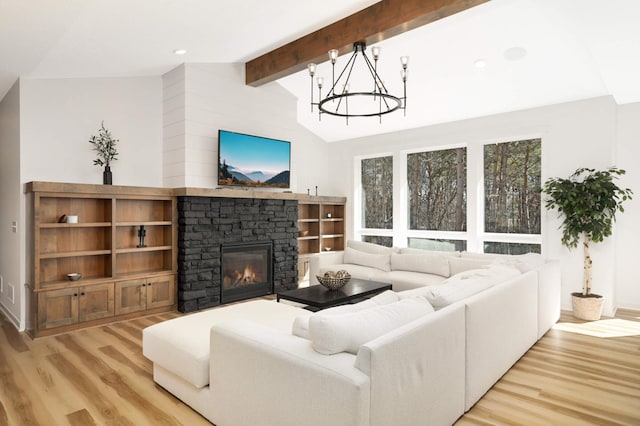 15359 Quamba St NE, Ham Lake, MN 55304 - living area with wood finished floors, a chandelier, and a fireplace