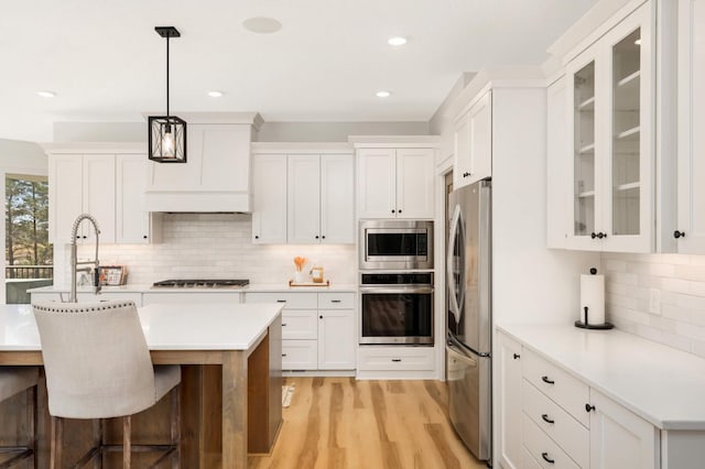 15359 Quamba St NE, Ham Lake, MN 55304 - kitchen with appliances with stainless steel finishes, backsplash, light countertops, white cabinetry, and recessed lighting