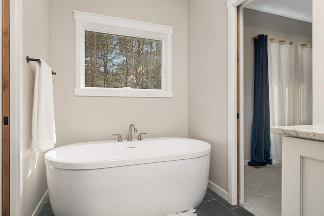 15359 Quamba St NE, Ham Lake, MN 55304 - full bathroom featuring a freestanding bath, baseboards, tile patterned flooring, and vanity
