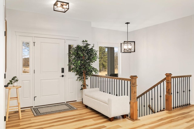 15359 Quamba St NE, Ham Lake, MN 55304 - entrance foyer with light wood finished floors and a chandelier