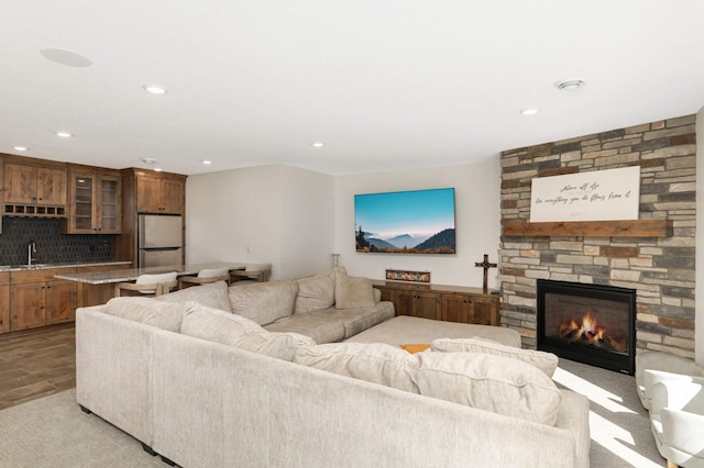 15359 Quamba St NE, Ham Lake, MN 55304 - living room featuring a fireplace, recessed lighting, bar area, and light wood-style floors