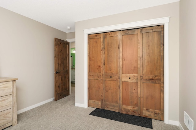 15359 Quamba St NE, Ham Lake, MN 55304 - unfurnished bedroom featuring light carpet, a closet, and baseboards