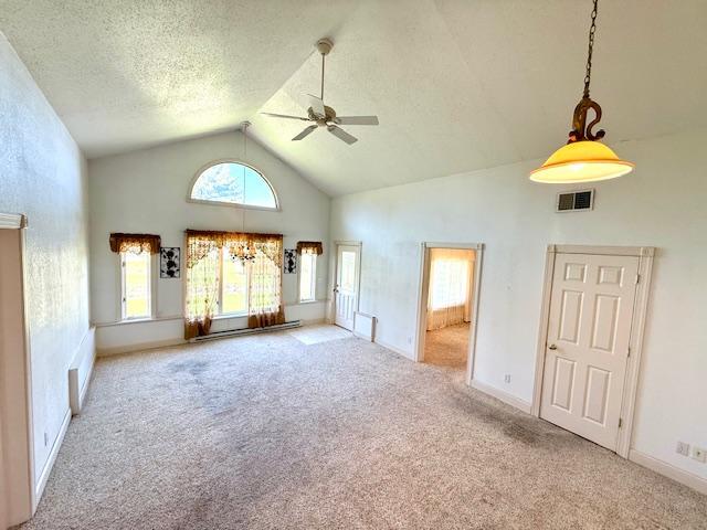 421 Main St E, Eitzen, MN 55931 - unfurnished living room with ceiling fan, high vaulted ceiling, carpet floors, healthy amount of natural light, and a textured ceiling