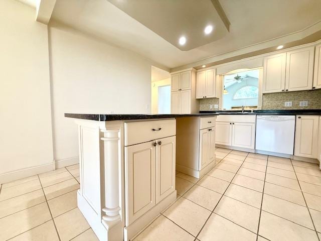 421 Main St E, Eitzen, MN 55931 - kitchen featuring dishwasher, light tile patterned floors, dark countertops, tasteful backsplash, and a center island