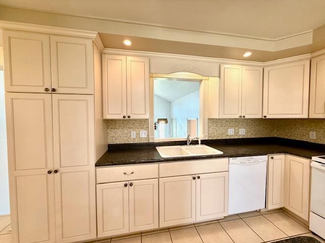 421 Main St E, Eitzen, MN 55931 - kitchen with white dishwasher, a sink, dark countertops, white cabinets, and recessed lighting