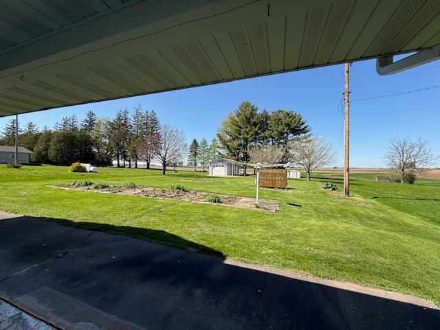 421 Main St E, Eitzen, MN 55931 - surrounding community featuring a lawn, an outdoor structure, and a storage unit