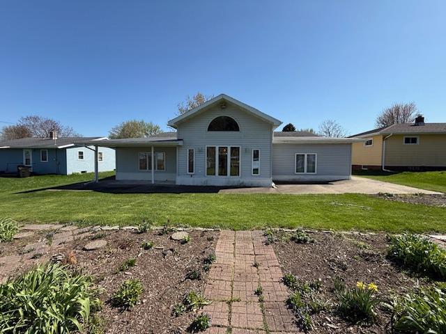 421 Main St E, Eitzen, MN 55931 - back of property with a lawn and a patio area