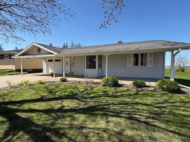 421 Main St E, Eitzen, MN 55931 - single story home with concrete driveway, an attached garage, a front lawn, and covered porch