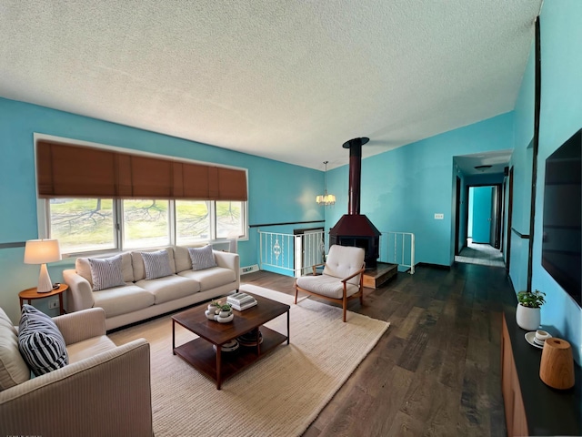 4806 Monroe St NE, Columbia Heights, MN 55421 - living room with a wood stove, a textured ceiling, and wood finished floors