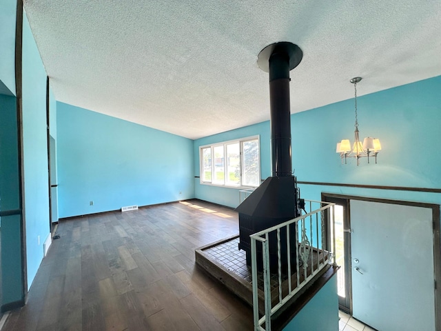4806 Monroe St NE, Columbia Heights, MN 55421 - living area with a chandelier, a textured ceiling, wood finished floors, and baseboards