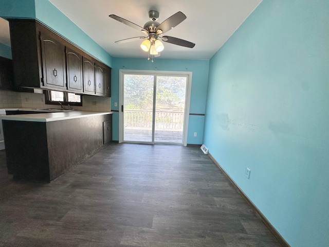 4806 Monroe St NE, Columbia Heights, MN 55421 - kitchen featuring decorative backsplash, ceiling fan, dark wood-style floors, baseboards, and a sink