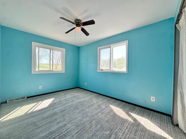 4806 Monroe St NE, Columbia Heights, MN 55421 - unfurnished room with healthy amount of natural light, carpet flooring, and a ceiling fan