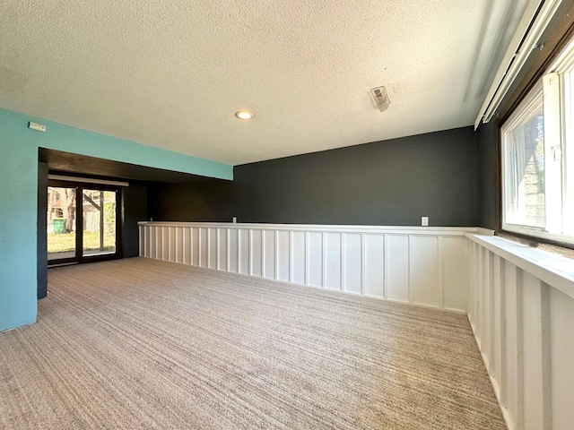 4806 Monroe St NE, Columbia Heights, MN 55421 - carpeted empty room with a wainscoted wall and a textured ceiling