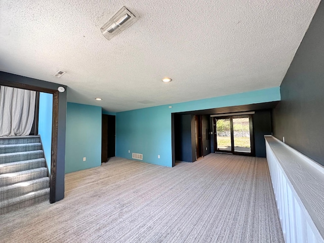 4806 Monroe St NE, Columbia Heights, MN 55421 - unfurnished living room with a textured ceiling, light carpet, stairway, and recessed lighting