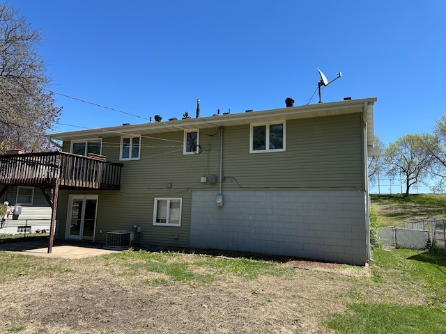 4806 Monroe St NE, Columbia Heights, MN 55421 - back of property featuring fence, a wooden deck, a patio, and cooling unit