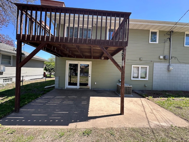 4806 Monroe St NE, Columbia Heights, MN 55421 - back of property with central AC, a wooden deck, a patio, and fence