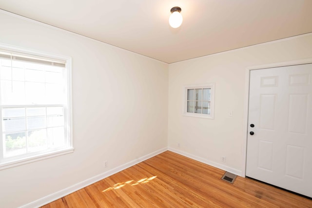 spare room with light wood finished floors and baseboards