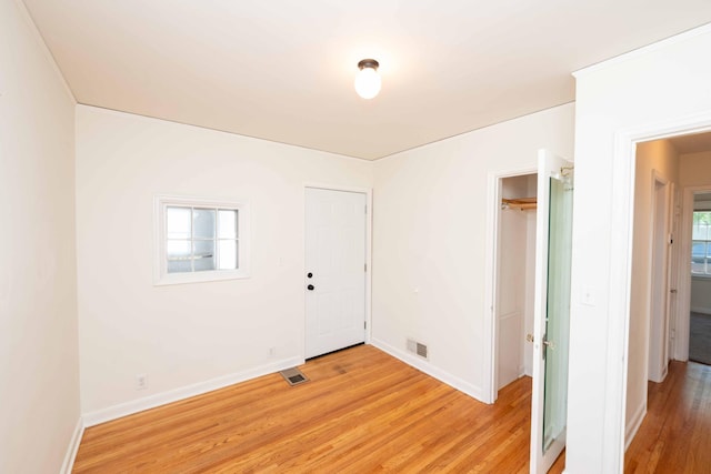 empty room with light wood-type flooring and baseboards